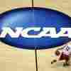 FILE - Wisconsin's Traevon Jackson dribbles in front of the NCAA logo during practice at the NCAA men's college basketball tournament March 26, 2014, in Anaheim, California.